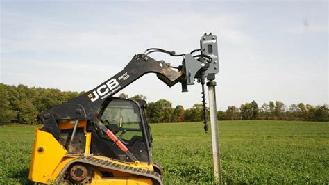 mini digger vibrating post driver|skid steer slide post driver.